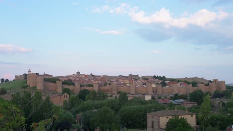 twilight landscape shot of ávila, showcasing the old town and its medieval walls, a unesco world heritage site.