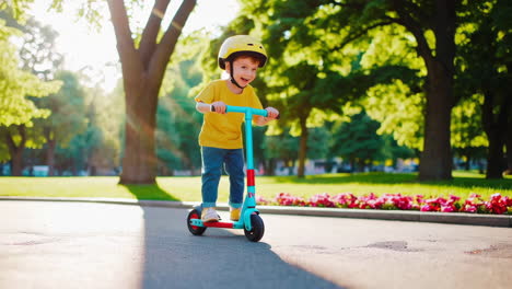 happy child riding a scooter in a sunny park