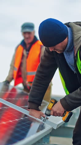 technician connecting solar panel. technicians working with electrical screwdriver installing solar panel to metal platform system