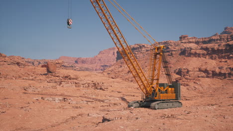 a yellow crane stands in a desert landscape