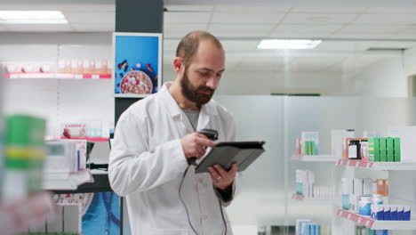 Pharmacy-clerk-inspects-supply-of-pharmaceuticals-on-aisles