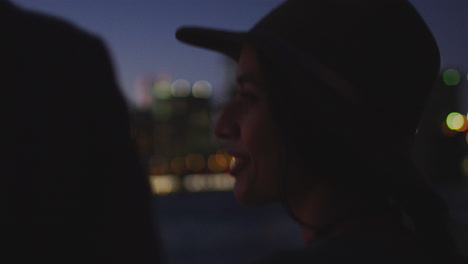 woman looking at illuminated manhattan skyline at dusk