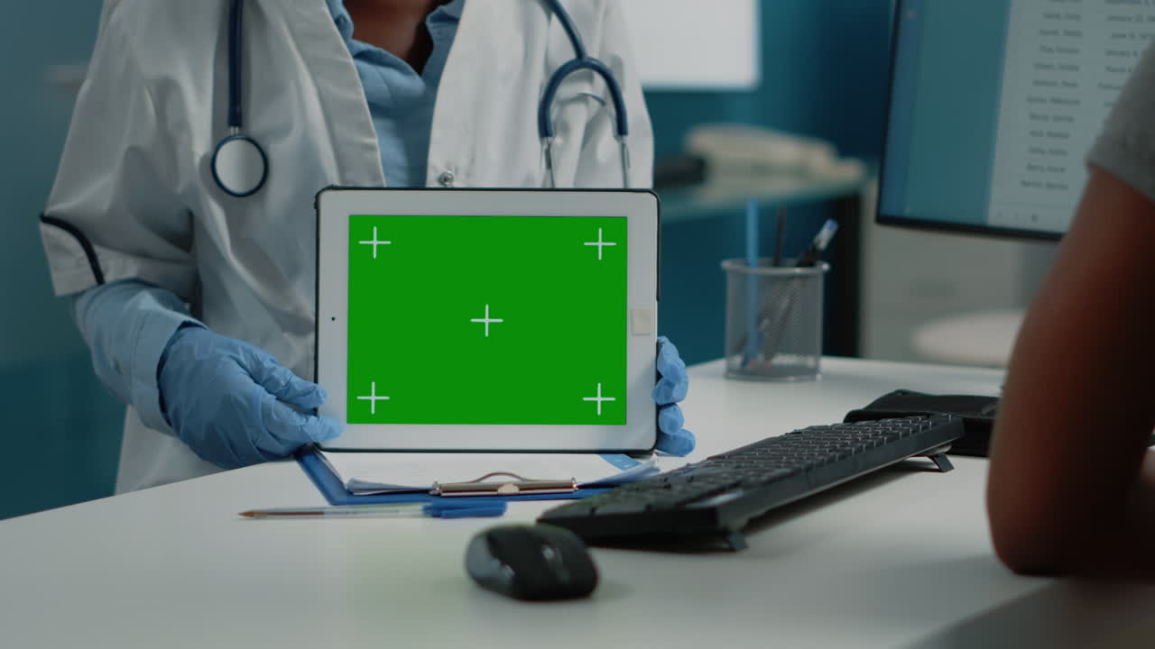 Doctor holding tablet with green screen