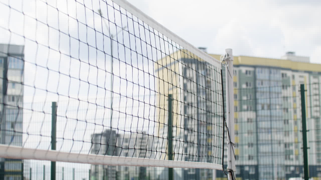 Volleyball net and and buildings in the background