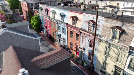 colorful row of houses in low class district of american town during sunny day