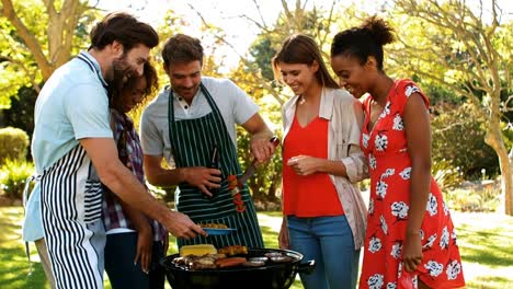 group of happy friends preparing barbecue