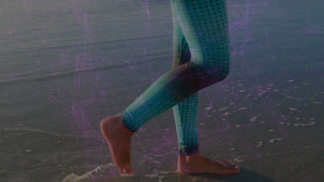 Walking on beach, legs in patterned leggings with animation of digital network