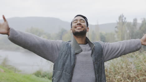 travel, open arms or happy man by lake in nature