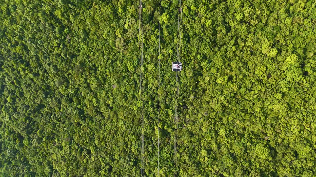 Aerial: world's longest three-rope cable car in the world during the day in Sunset Town, Phu Quoc Island, Vietnam, top-down drone shot