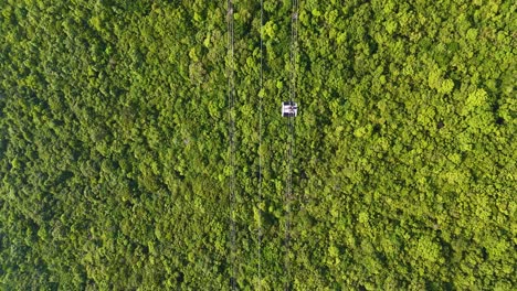 aerial: world's longest three-rope cable car in the world during the day in sunset town, phu quoc island, vietnam, top-down drone shot