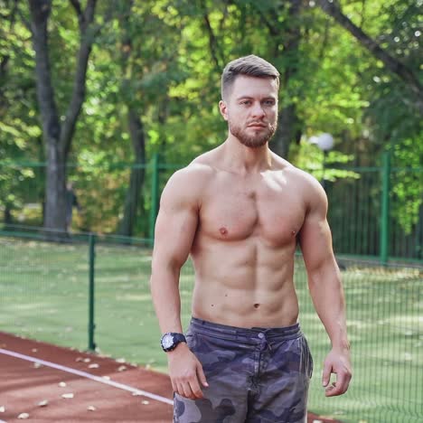 man posing on racetrack at stadium