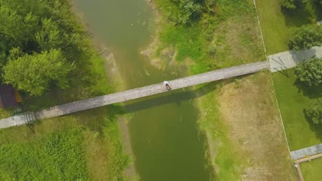 camera-turns-above-newly-wedded-couple-on-old-wooden-bridge