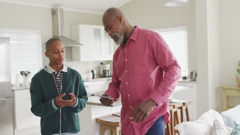 Video-of-nervous-african-american-father-arguing-with-son-in-kitchen