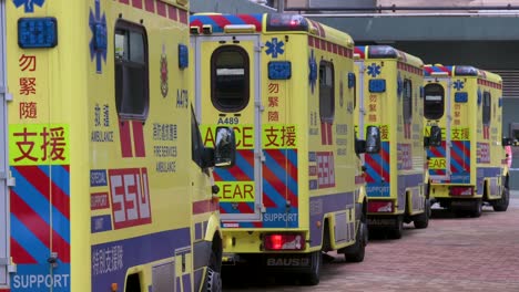 a row of ambulances are seen parked outside a building placed under covid-19 coronavirus lockdown at a public housing complex after a large number of residents tested positive