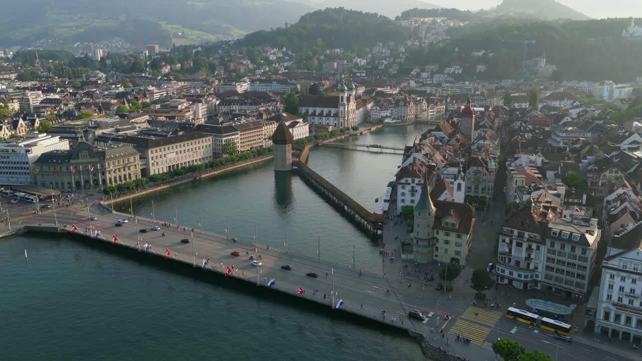 Historic lakefront bridge crossing the Reuss River in early morning light in central Lucerne