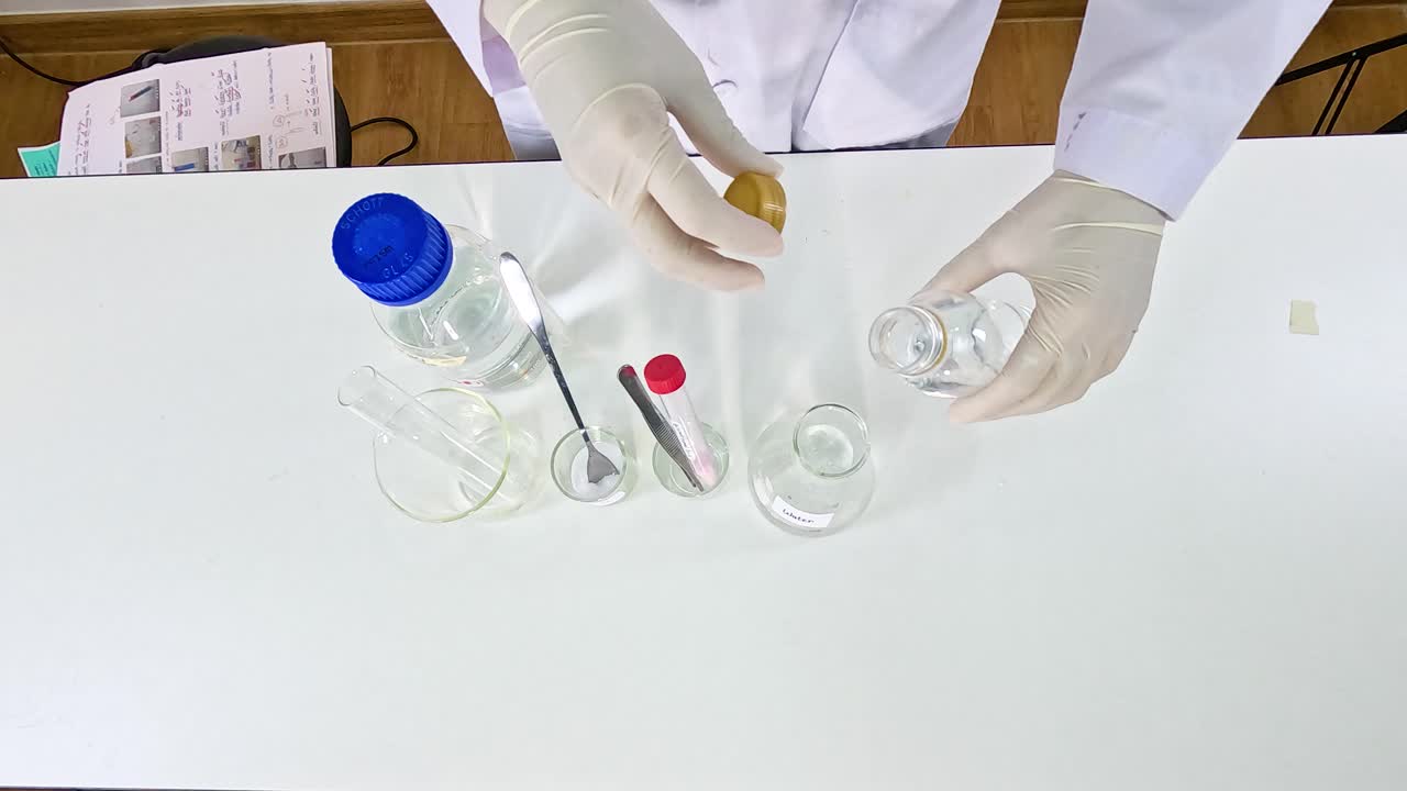 Scientist conducts a bromothymol blue experiment on a white table using various lab equipment under bright lighting