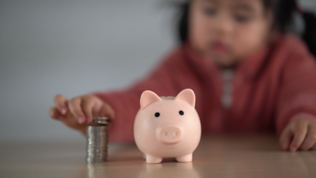 Family Saving money. Asian baby girl daughter plan to spend the future in earnest, finance and saving, family and financial concept.