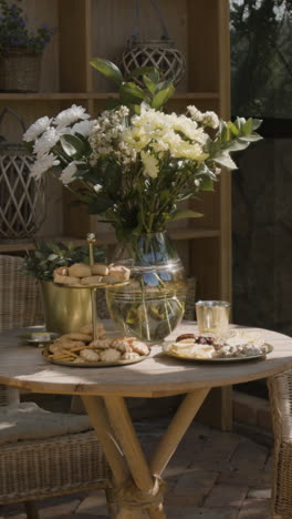 outdoor table setting with flowers and snacks