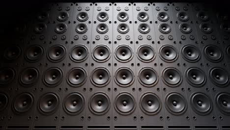 playing cabinet speakers stacked on a concert stage in form of an endless wall pattern. powerful, versatile stage equipment lit by a spotlight, creating a moody and climatic music festival atmosphere.