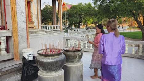 women praying at a temple