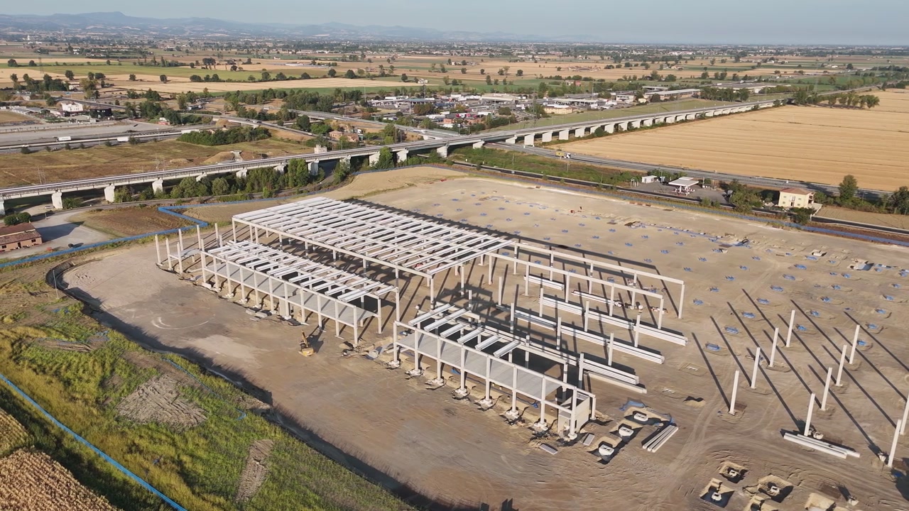 Construção do Parque Empresarial de Fiorenzuola em Barabasca, Fiorenzuola d'Arda, Piacenza, ao lado da ferrovia Milão-Bolonha e do corredor A1, através das terras agrícolas do Vale do Pó, imagem de drone.
