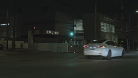 a static shot of a busy city road where few cars are seen running at night