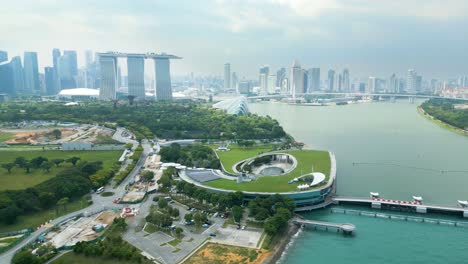 fresh-Singapore-morning-skyline-aerial-shot-with-focus-at-Marina-bay,-gardens-and-skyscrapers