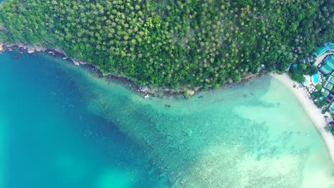 Blue-calm-lagoon,-hills-with-palms-turquoise-sea-sandy-beach