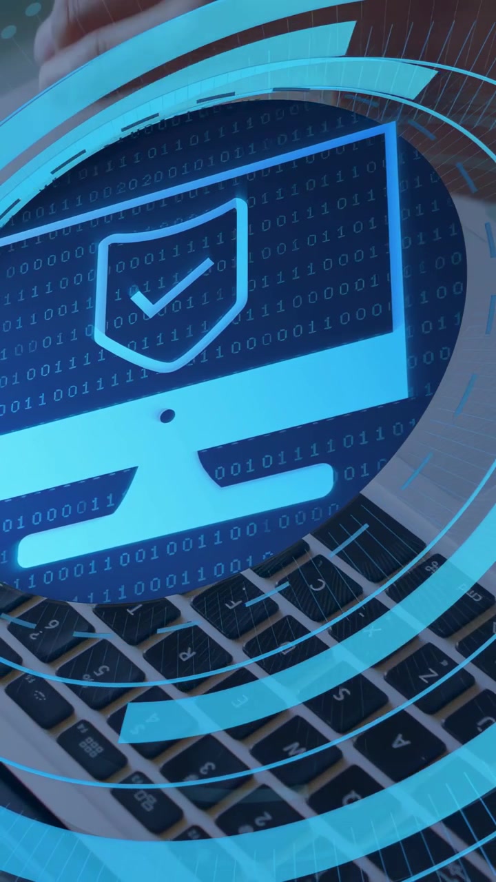 Vertical video: Man typing on laptop, initiating security HUD with shield icon protecting data
