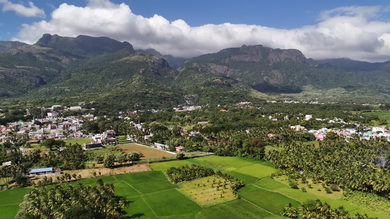 Breathtaking drone shot of Courtallam, Tamil Nadu — where misty mountains, green forests, and waterfalls create a serene blend of nature and town life