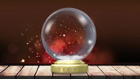 animation of christmas snow globe with snow falling and red spot lights in background