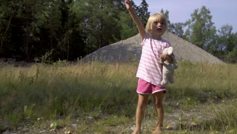 cute three year old girl on adventure, walking barefoot in lovely summer weather, gimbal 4k