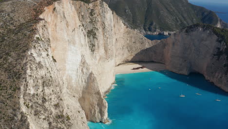 turquoise water of shipwreck beach surrounded with towering cliffs in zakynthos island, greece