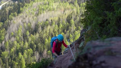 woman climbs up the rock