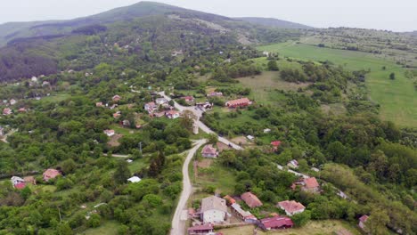 orbiting drone shot of the mountains and fields of tsarichina hole village, a mysterious place in a bulgarian countryside