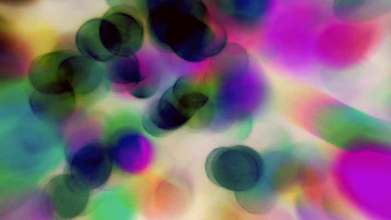 Abstraktní negativní barevné bokeh pozadí s pohybem.