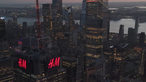aerial view of skyscrapers in times square and hudson yards, colorful dusk in ny