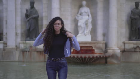 young woman in front of a fountain