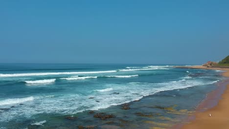 flying drone over the beach-sea shoreline above the sea and sand at durban south africa