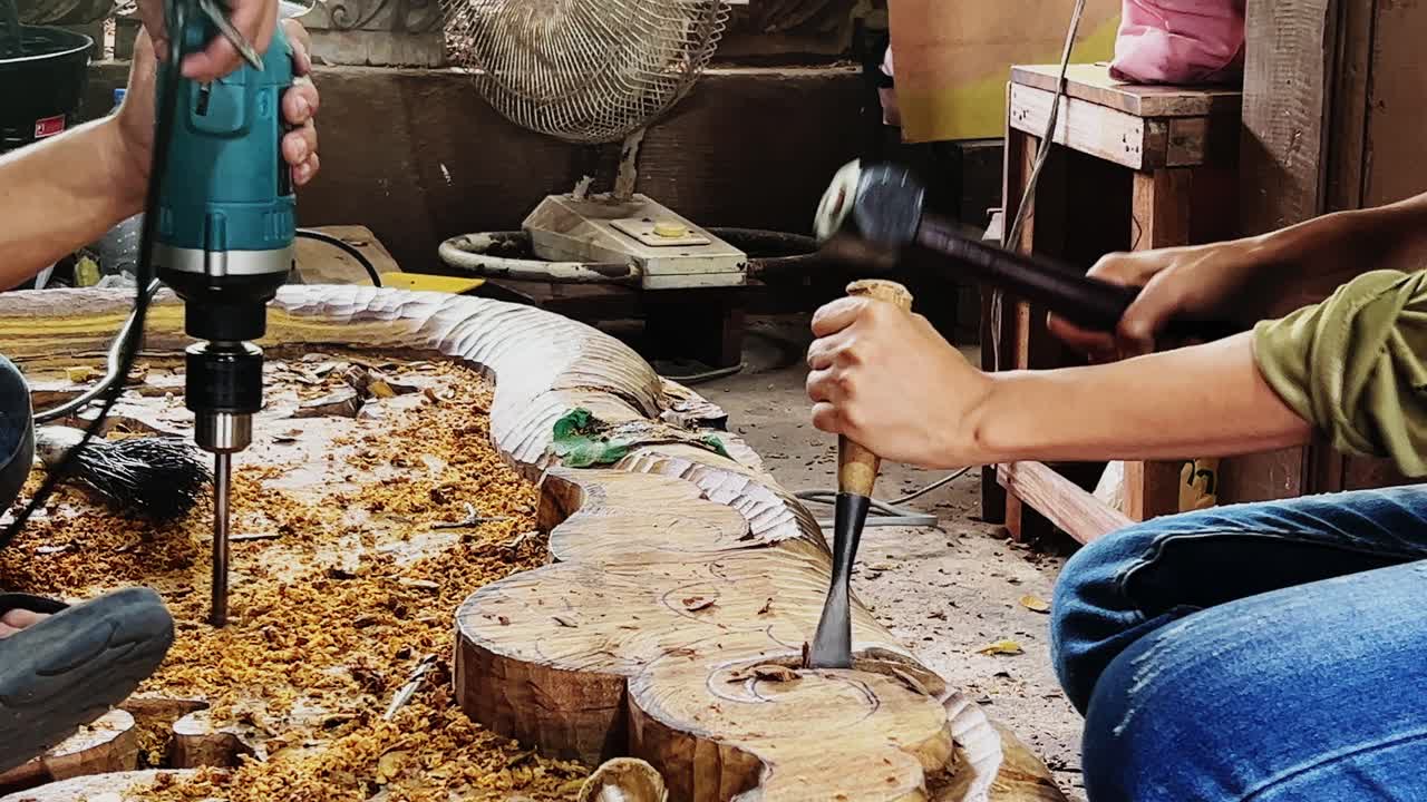 Few people are sculpturing the wood in closeup in 4k