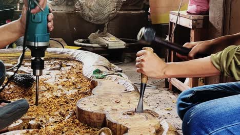 few people are sculpturing the wood in closeup in 4k