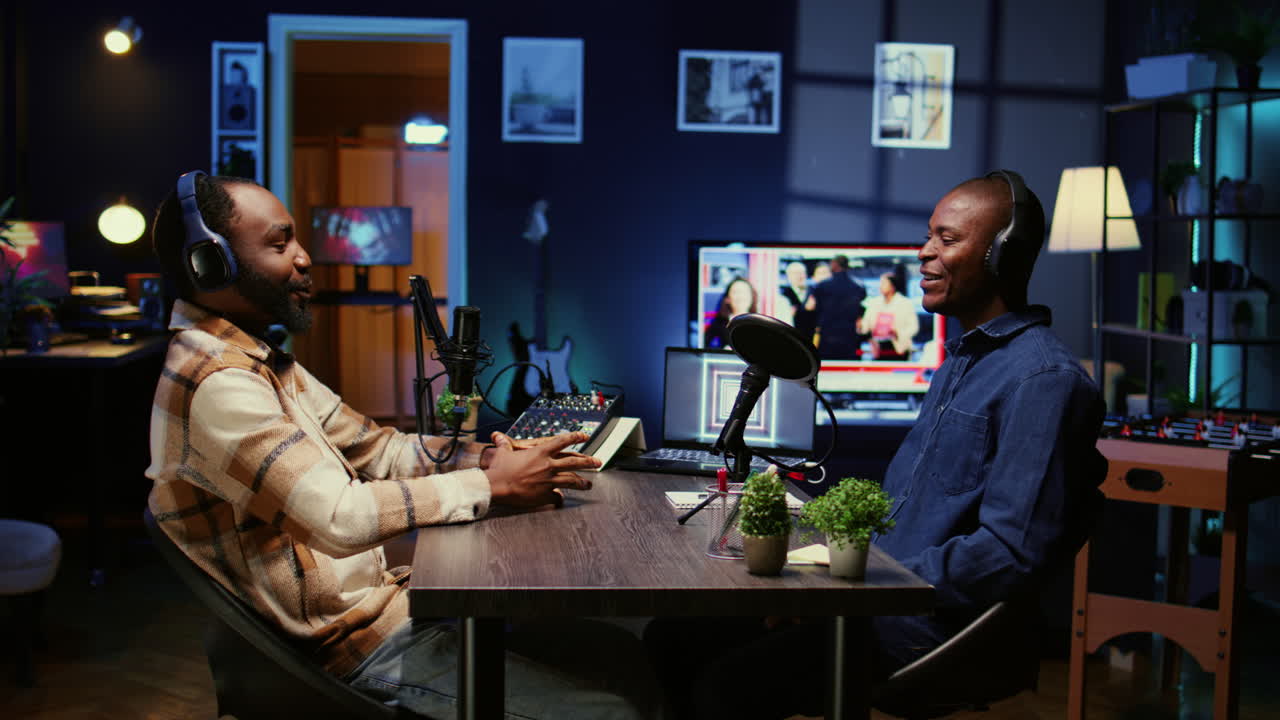 Podcast presenter having live conversation with man, recording discussion for audience