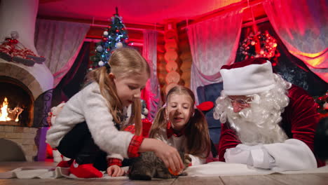 lovely little girl indoors at christmas. cute children reading a letter to the santa. beautiful small girls spending time on xmas background at home