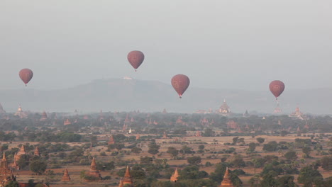 balloons fly above the stone temple on the plains of pagan bagan burma myanmar 1