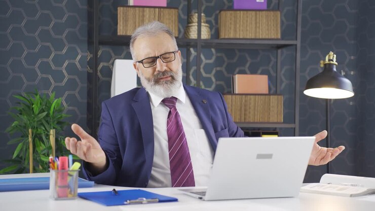 Businessman looking at camera tired from work.