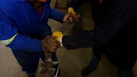 two metalsmiths working in workshop 4k