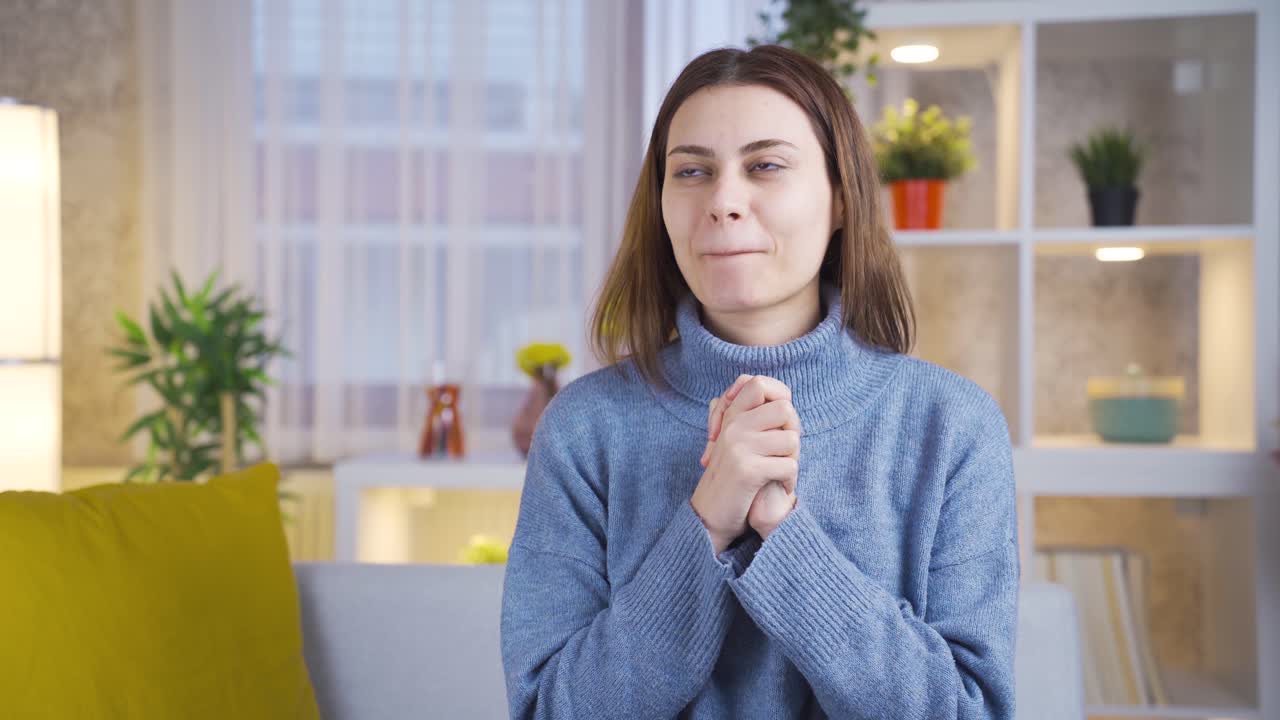 y emocionado retrato animado de una joven feliz y linda en el sofá de su casa.