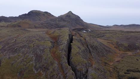 aerial of famous volcanic lambafell fissure in iceland, crack in earths surface