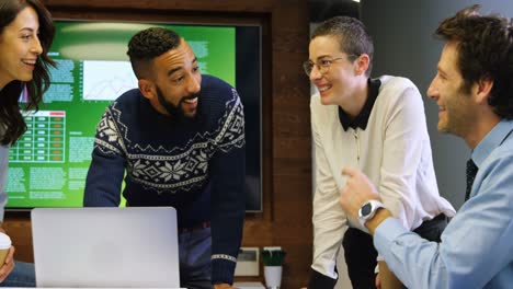 Executives-discussing-on-laptop-in-conference-room-at-office-4k