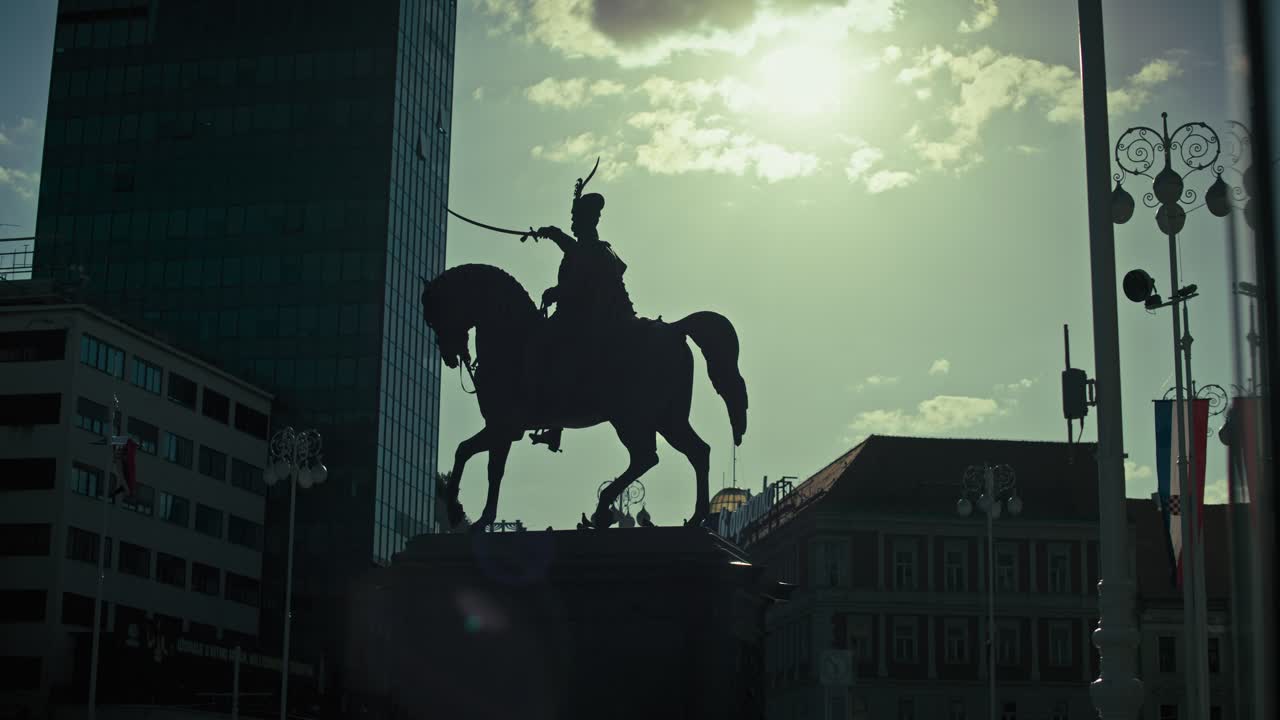Silhouette of the iconic equestrian statue of Josip Jelačić against the sunlit sky in Zagreb’s main square